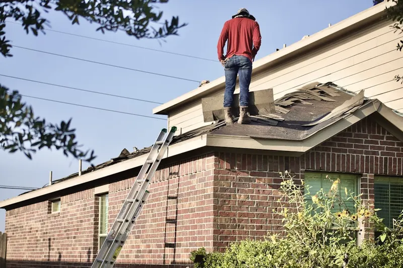 Professional roofer working on a residential roof in Lander